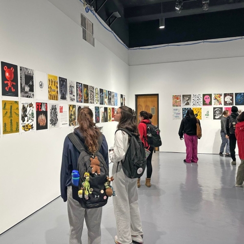 People browse posters in an AI exhibition at UMD.